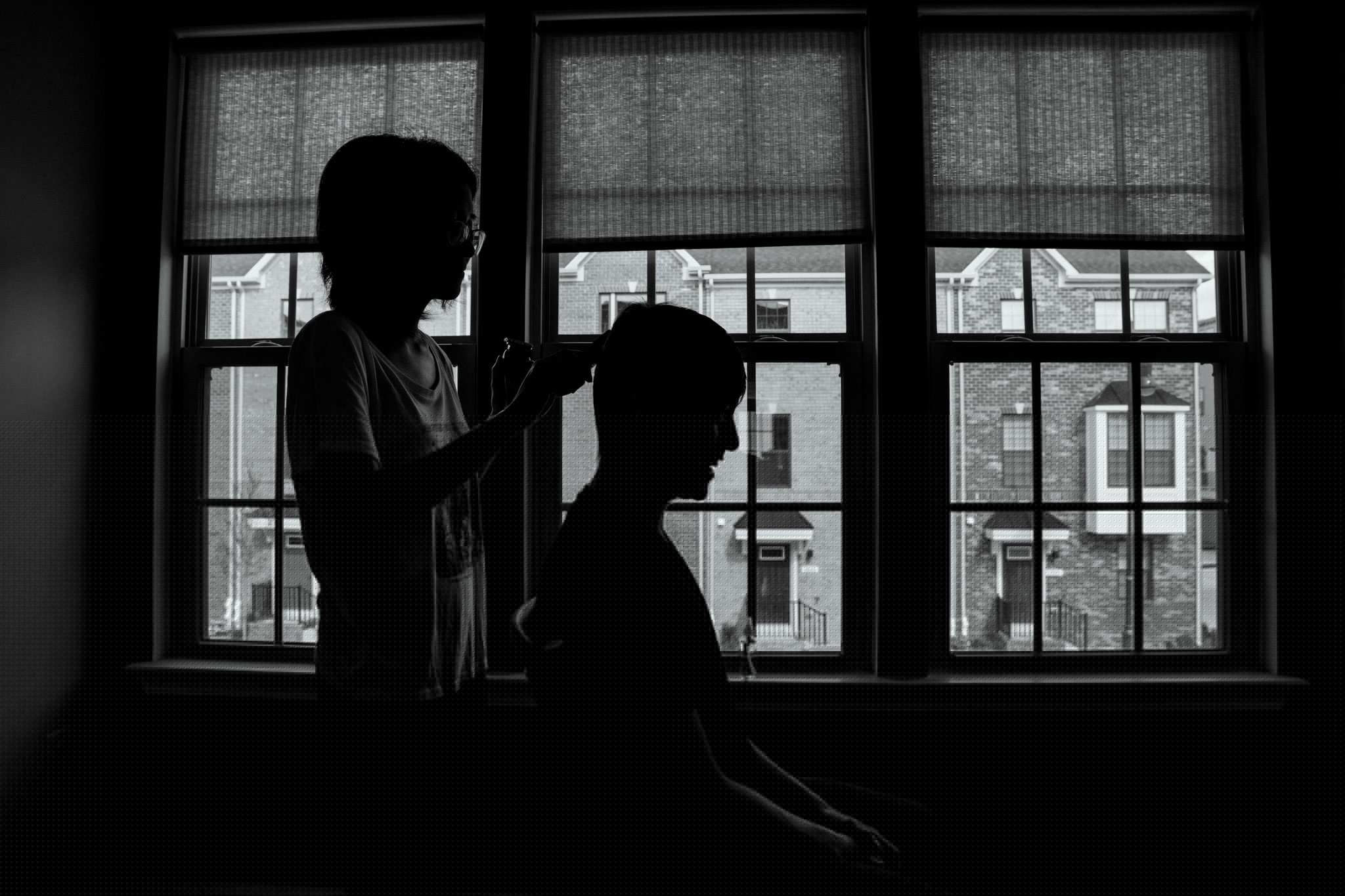 a woman cutting her husband's hair