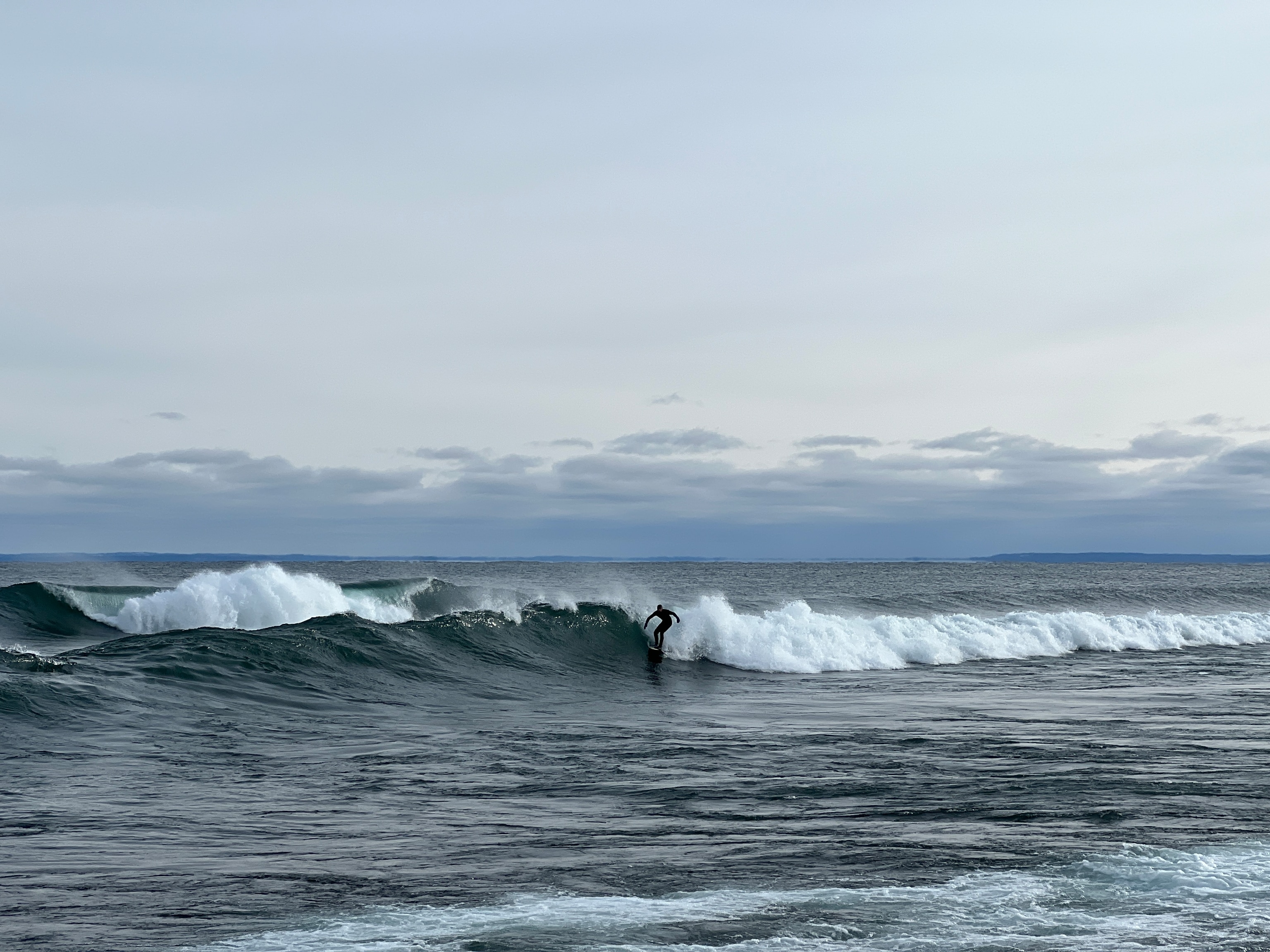 Surfer reaping the tail end of a giant nor'easter storm, catching 8-10 foot waves--monstrous for Lake Superior. Lake Superior is the largest body of freshwater by surface area on the planet. It's also one of the least explored and least understood lakes in the world largely due to the fact that oceans have historically garnered exponentially more dollars for research.
