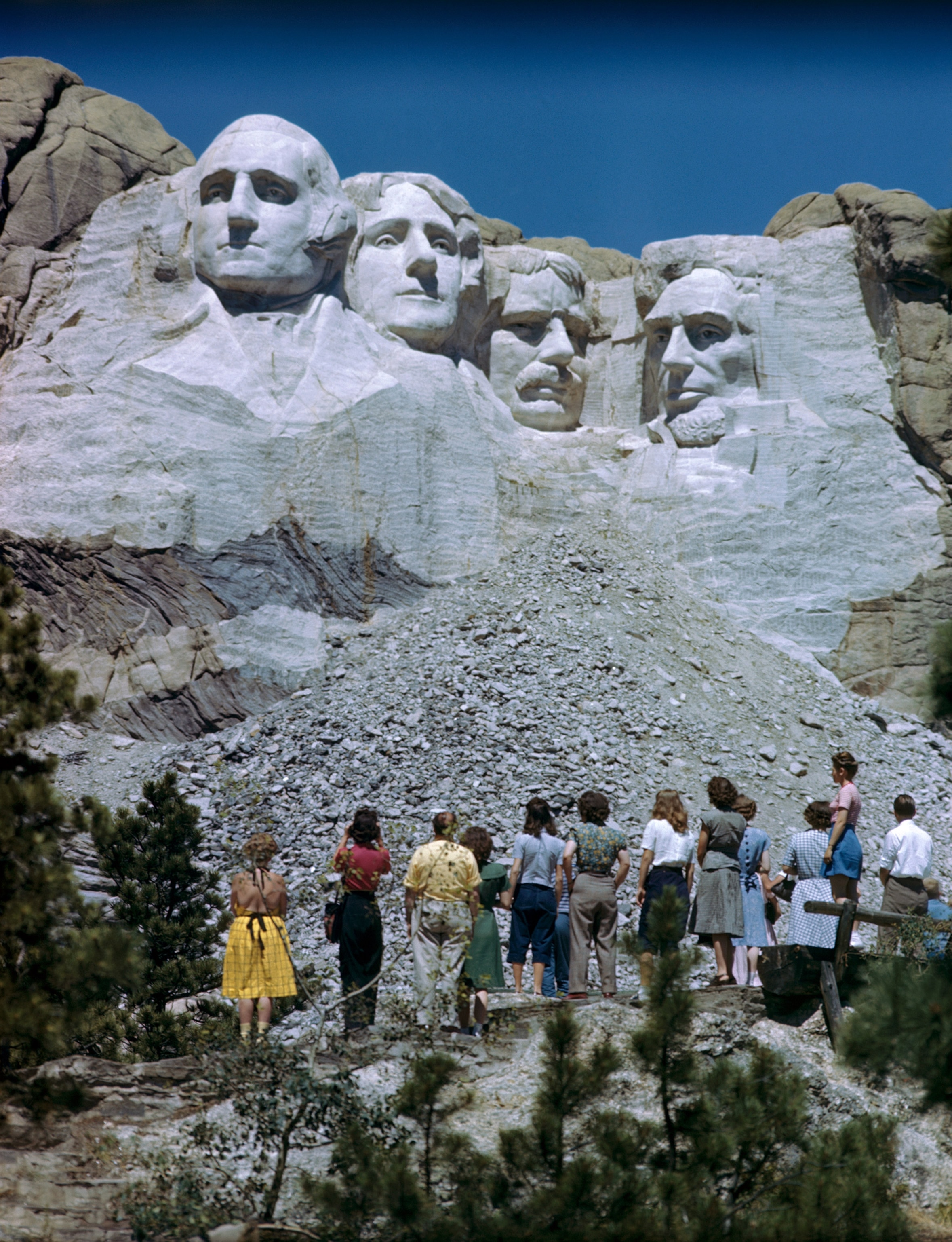 Tourists looking up at Mount Rushmore