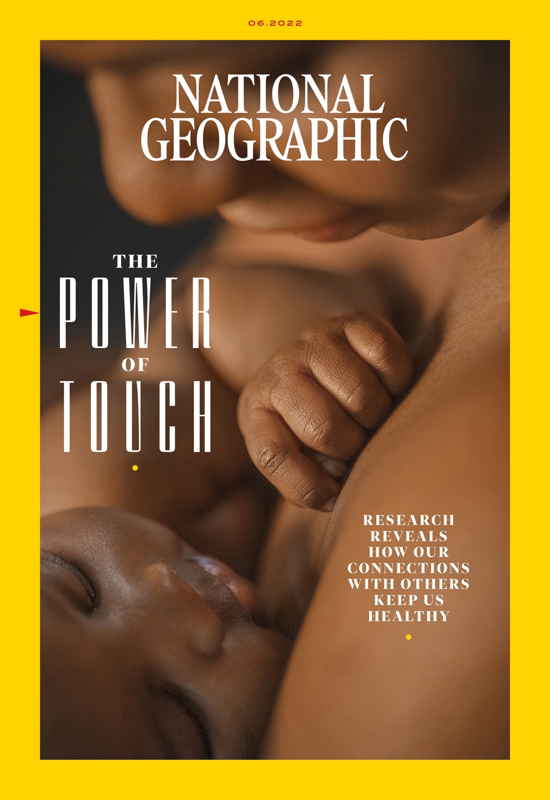 Picture of a mother holding her baby close to her. Both are bare-skinned and the baby's fist is curled tightly into a ball pressed into the mother's skin. The picture is surrounded by a yellow border.