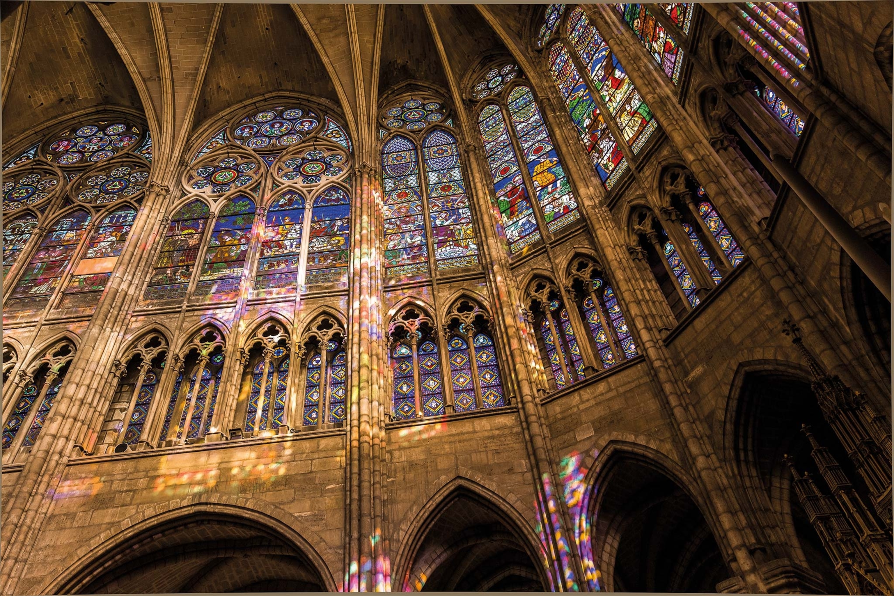 The large stained glass windows are seen inside the Basilique Cathédrale de Saint-Denis
