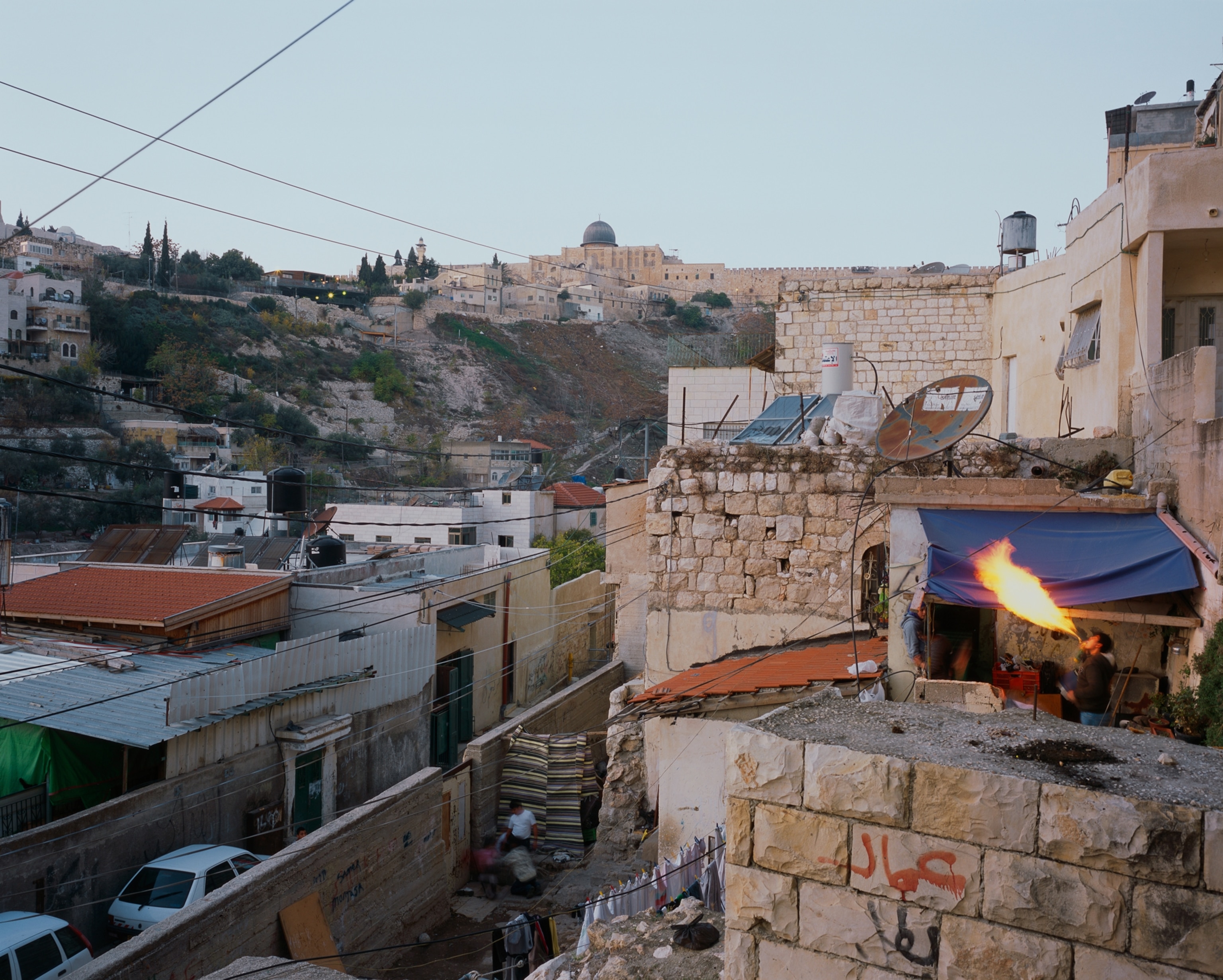 Mansour Yousef al-Shyoukhi practicing the risky art of fire-breathing in Silwan