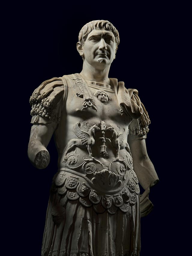 Picture of a marble statue of Trajan wearing armor typically worn in parades